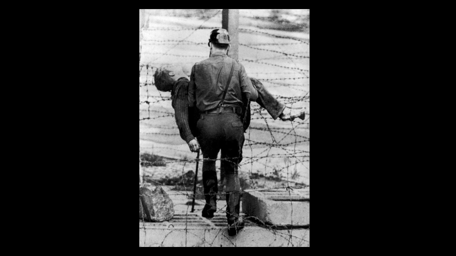 El 17 de agosto de 1962 se produjo la primera víctima del muro de Berlín. En la imagen, un policía germano oriental recoge el cuerpo sin vida del Peter Fechter, de 18 años, que fue abatido por los disparos de la policía cuando intentaba cruzar el muro de Berlín